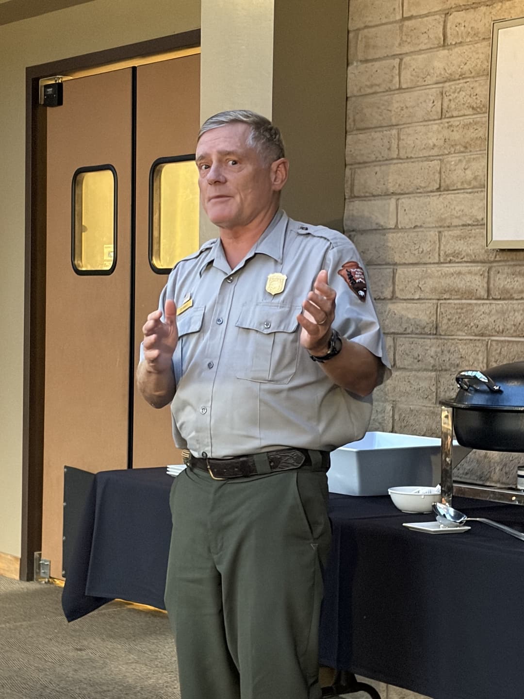 Grand Canyon National Park Superintendent Keable, in National Park Service uniform, speaking to members.